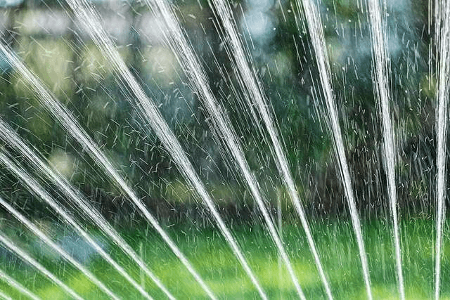 Close up of hose power washing a dirty deck.
